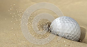 Golf Ball In Action Hitting Bunker Sand