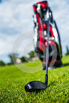 Golf ball ang club on golf green grass natural fairway