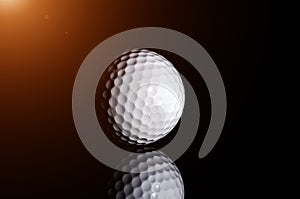 Golf ball on black background