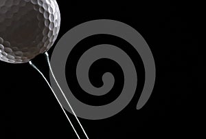 Golf ball black on tee