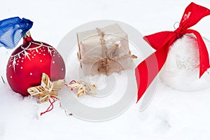 Golf ball and Christmas ornament on green grass.