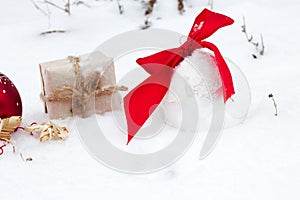 Golf ball and Christmas ornament on green grass.