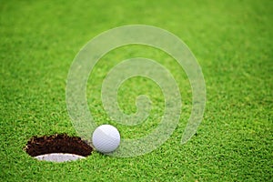 Golf ball close to hole