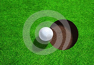 Golf Ball Close to Hole With Copy Space