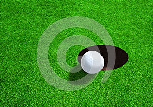 Golf Ball Close to Hole With Copy Space