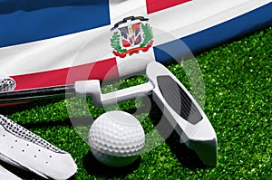 Golf ball and club with flag of Dominican republic on green grass. Golf championship in Dominican republic