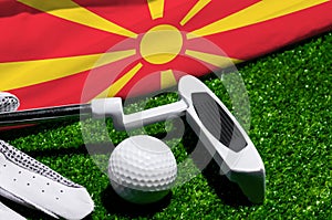 Golf ball and club with flag of Macedonia on green grass. Golf championship in Macedonia