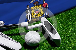 Golf ball and club with flag of Wisconsin on green grass. Golf championship in Wisconsin