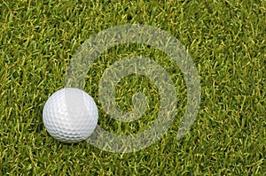 Golf ball on course with green grass.