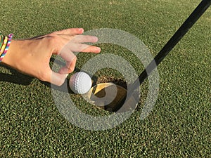 Golf Ball On Edge of Hole