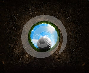 Golf ball falling into the cup