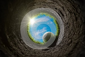 Golf ball is falling into hole. View from inside of hole. 3D rendered illustration.