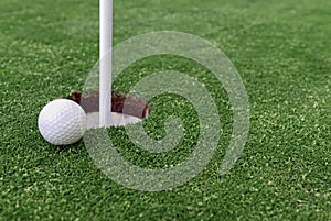 Golf ball and Flagstick of Manicured grass of putting green