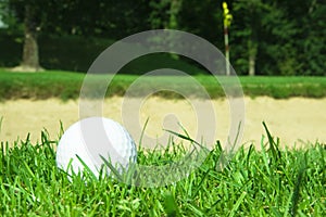 Golf ball in front of bunker