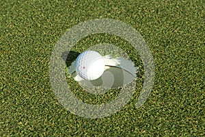 Golf ball goin golf hole