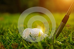 golf ball and golf club in beautiful golf course at sunset background