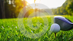 Golf ball and golf club in a beautiful golf course at sunset background
