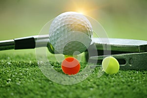 Golf ball and golf club in beautiful golf course at sunset background. Golf ball on green in golf course at Thailand