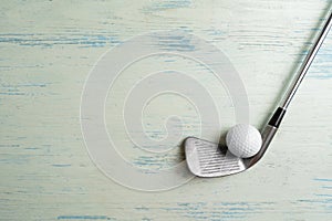 golf ball and golf club on blue background, sport concept