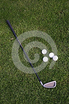 Golf-ball and golf-club on the grass