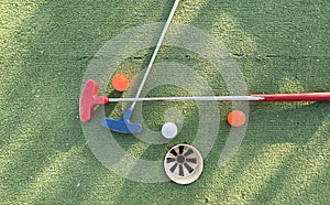 Golf ball and golf club on green in the evening golf course with sunshine