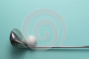 Golf ball and golf club on green table background, flat lay,  sport concept