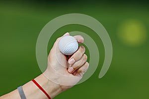 Golf ball in golfer`s hand