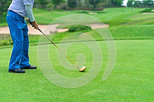 Golf ball on grass behind driver at golf club