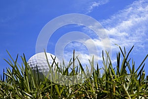 Golf Ball in Grass with Blue Sky