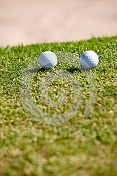 Golf ball, grass and closeup for sports, play and hobby for recreation in summer outdoor. Equipment, round and mockup on