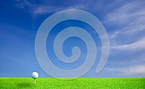 Golf ball on grass under blue sky