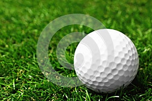 Golf ball on green course outdoors. Space for text