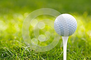 Golf ball on green grass bokeh background