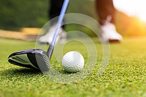 Golf ball on green grass ready to be struck at golf club photo