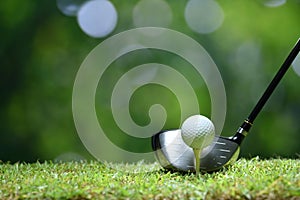 Golf ball on green grass ready to be struck on golf course