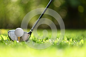 Golf ball on green grass ready to be struck on golf course background