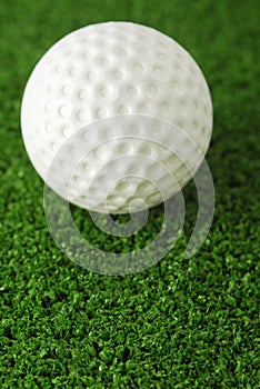 Golf ball on the green grass turf