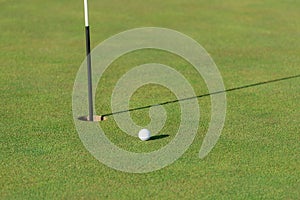 Golf ball, green and pin