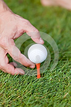 Golf ball and iron on green grass detail macro