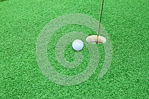 Golf ball on lip of cup