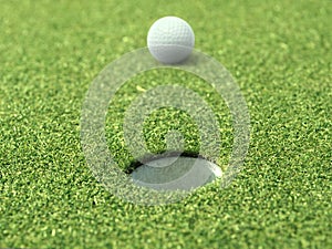Golf ball on lip of cup of lovely beautiful golf course