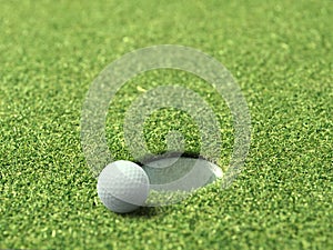 Golf ball on lip of cup of lovely beautiful golf course