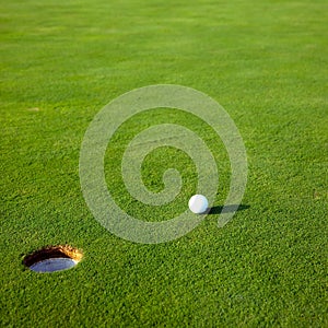 Golf ball near hole photo