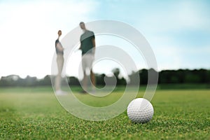 Golf ball near hole on course