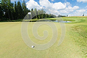 Golf ball near the hole with pole