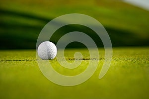 Golf Ball Next To A Hole 