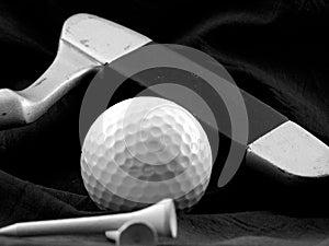 Golf ball, putter and tee.