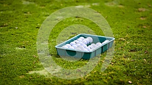 Golf ball putting on green grass near hole golf to win in game at golf course with blur background and sunlight ray