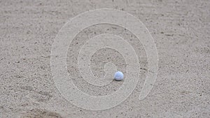 Golf ball putting on sand near hole golf to win in game at golf course with blur background and sunlight ray