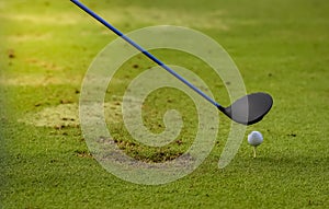 Golf ball putting on sand near hole golf to win in game at golf course with blur background and sunlight ray